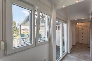 a hallway with two windows and a balcony at Luxury flats in city centre in Pula