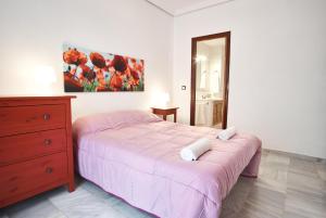 A bed or beds in a room at Pureza Oasis Suite