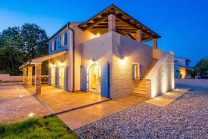 a house with lights on the front of it at Villa Leticia in Hreljići