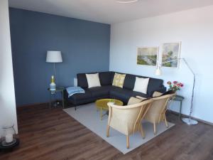 a living room with a couch and a table at Leuchtturmblick in Wangerooge