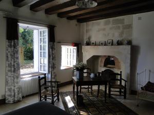a living room with a table and a fireplace at La Héraudière Bed & Breakfast in Tours +33 photos