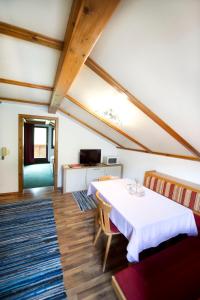 a room with two beds and a table and chairs at Pension Baldauf - Dorf 31 in Kleinarl