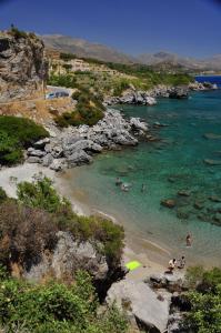 a group of people in the water at a beach at Creta Spirit in Plakias