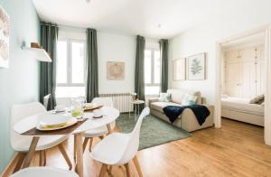 salon ze stołem, krzesłami i kanapą w obiekcie Gran Via I Santa Ana w Madrycie