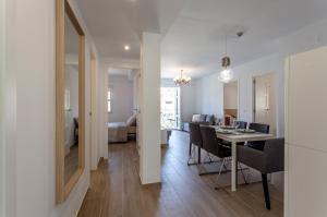 a dining room and living room with a table and chairs at Valencia Flat Rental Malvarrosa Beach zone in Valencia