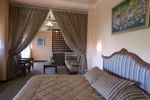 丹吉爾的住宿－夏拉酒店，一间卧室配有一张床、一张沙发和一把椅子