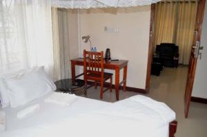 A bed or beds in a room at Cashewnut Hotel