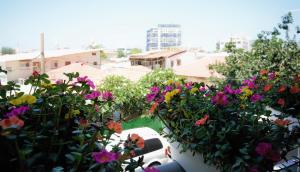 a bunch of flowers in a yard with buildings at 2R full of charm and style at heart of Florentine in Tel Aviv