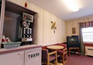 a room with a kitchen with a table and a tv at America's Best Value Inn-Athens in Athens