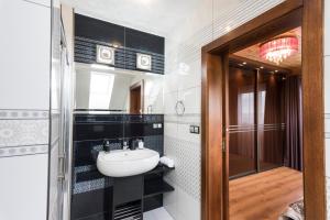 a bathroom with a sink and a mirror at Pillow House Tatras in Stará Lesná +28 photos