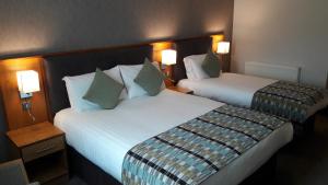 Krevet ili kreveti u jedinici u okviru objekta Westgrove Hotel