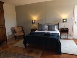 a bedroom with a bed and a chair at La Petite Auberge in Comps +9 photos