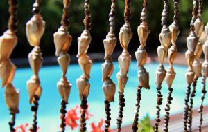 a close up of a wooden fence with beads at Boutique Vila Artemide in Palanga