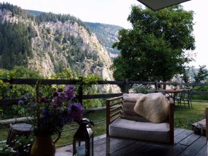 a chair on a deck with a view of a mountain at Swissalpschalet Chalet Timber Inn 4-5 in Blatten bei Naters
