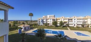 a large apartment building with a swimming pool at Beach Apartment Vilamoura Villa Columbus in Vilamoura