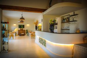 a restaurant with a counter and a dining room at Baglio Genovesi in Noto