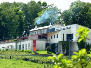 a white building with smoke coming out of it at Hotel Parrilla el Zangano in Boal