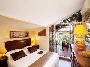 a bedroom with a large bed and a balcony at Pantheon Inn in Rome