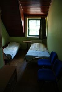 a room with two beds and a table and a window at Motel Warmiaki Bed&breakfast in Jadów