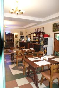 a dining room with wooden tables and chairs at Motel Warmiaki Bed&breakfast in Jadów