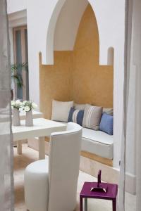 a living room with a couch and a table at Riad Dar Maya in Essaouira