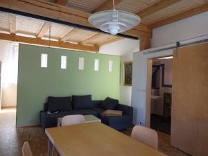 a living room with a blue couch and a table at Alte Scheune Rietzschelhof in Müglitztal