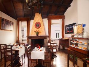 a restaurant with tables and chairs and a fireplace at Pantheon Inn in Rome