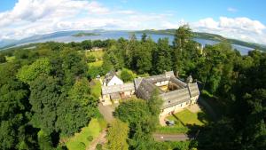 an aerial view of a large house in the trees at Coachouse in Balloch