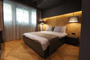 a bedroom with a large bed with a window at Hotel London B&B in Skopje