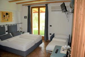 Posteľ alebo postele v izbe v ubytovaní Agritur La Cort