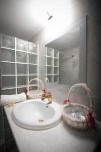 a bathroom with a sink and baskets on a counter at Aias Summer House in Aiándion