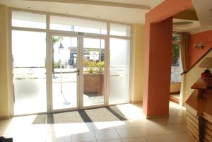 an open glass door in a room with a patio at Hotel Gran Crisol in Córdoba