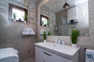 a bathroom with a white sink and a mirror at Estate Villa Duo in Biograd na Moru
