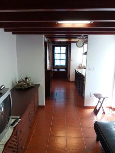 a kitchen with a tile floor and a kitchen with a table at Casa Lola in Villastose