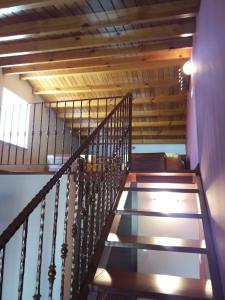 a staircase in a house with wooden walls and ceilings at Casa Lola in Villastose