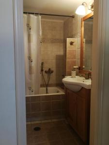 a bathroom with a tub and a sink and a shower at Casa Victoria in Katokhórion +17 photos