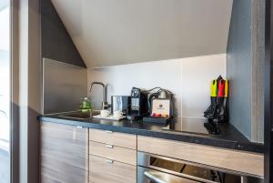 a kitchen with a sink and a counter top at CMG - Tour Eiffel - 75 in Paris