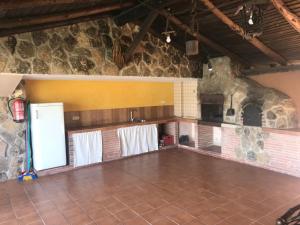 a large kitchen with a stone oven in a room at La Guarida del Oso in Candeleda