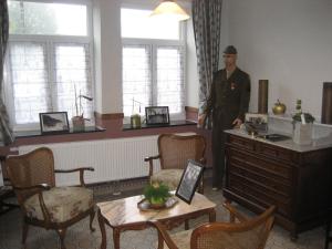 a man standing in a room with a table and chairs at Santa Fe - Lutrebois in Bastogne