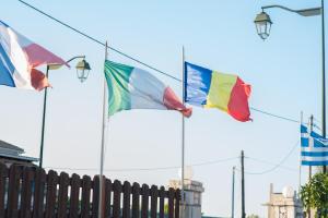 a group of flags flying in front of a fence at Villa Vita Holidays in Lefkada Town