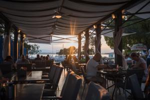 a group of people sitting at tables in a restaurant at B&B Galija in Crikvenica +80 photos