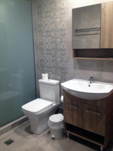 a bathroom with a white toilet and a sink at Hotel Thisvi in Stalís +20 photos