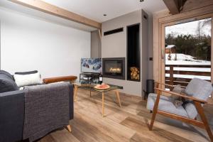 sala de estar con sofá y chimenea en Chalet De L'ours - Chamonix All Year, en Chamonix-Mont-Blanc