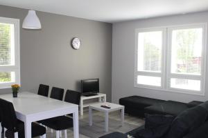 a living room with a couch and a table at Apartment Puistotie 4 in Pyhäjoki +2 photos