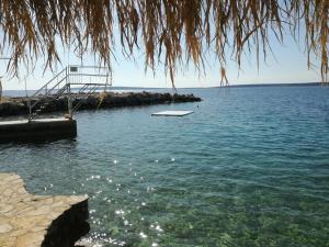 a boat sitting in the water next to a dock at Holiday Park Mandrice in Mandre