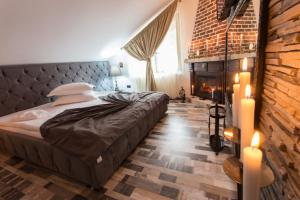 a bedroom with a large bed and a fireplace at Pension Casa Wenge in Sinaia