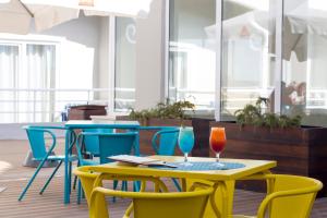 a table and chairs with two glasses on it at Star inn Peniche in Peniche