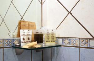 a shelf in a bathroom with some products on it at Hotel L'Aquila in LʼAquila