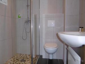 a bathroom with a toilet and a sink at Hôtel La Flore in Villefranche-sur-Mer