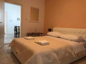 a bedroom with a large bed with towels on it at Apartmani Rija 3 in Pag